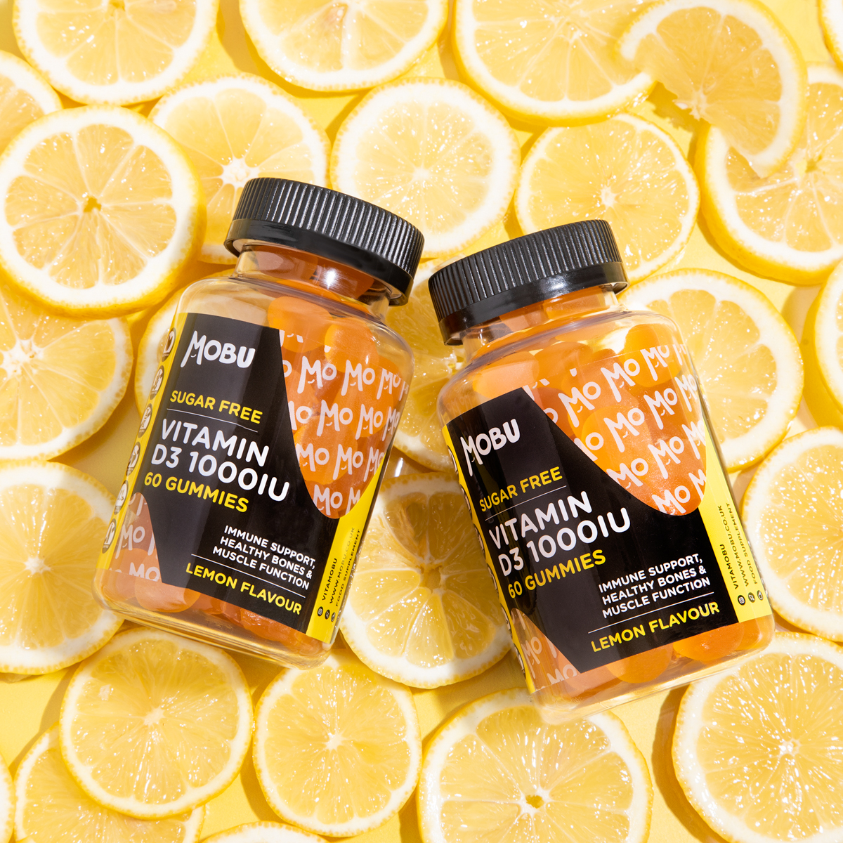 MOBU Vitamin Gummies displayed on background of oranges