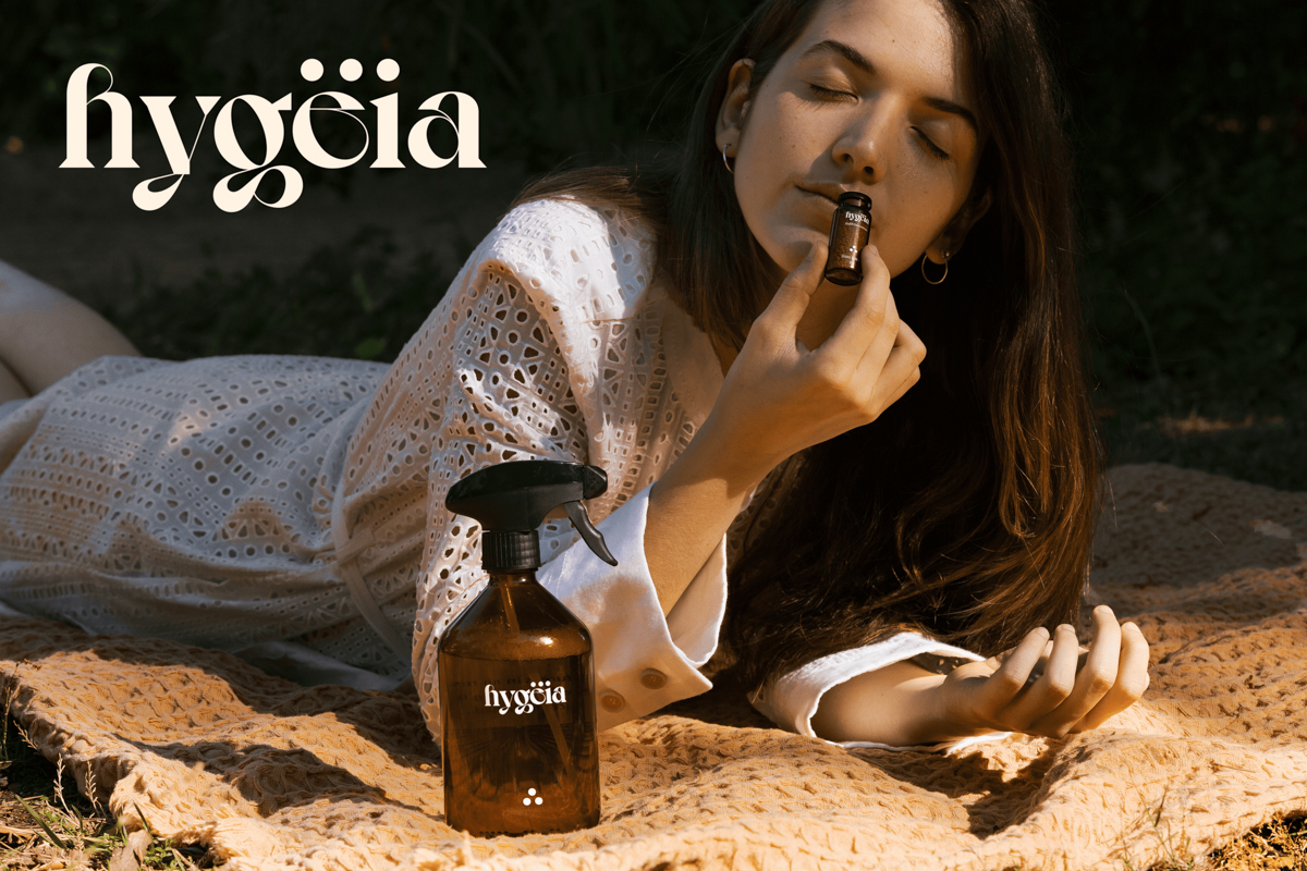 hygëia logo displayed on photo of woman smelling hygëia products